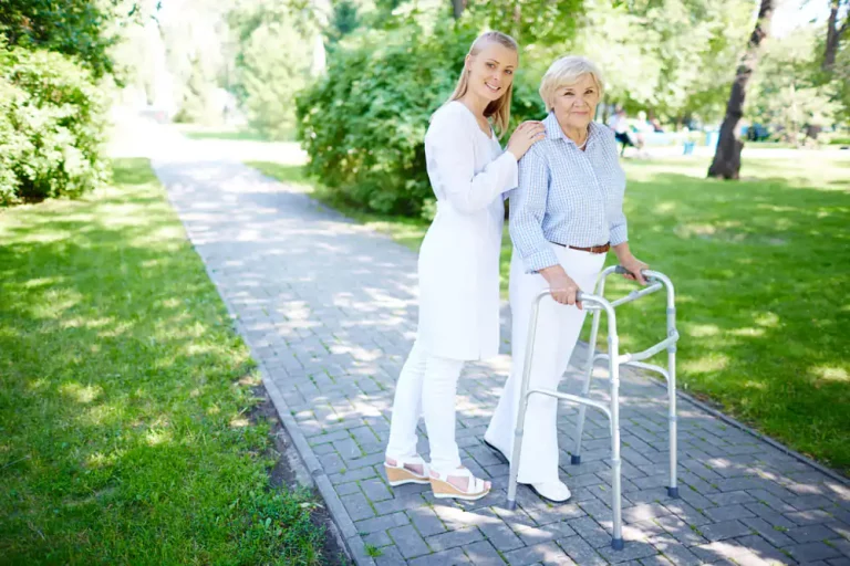 nurse-helping-senior-woman-to-use-walking-frame.jpg
